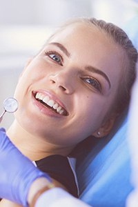 Woman in dental chair laughing