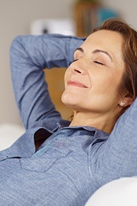 Relaxing woman with hands behind head