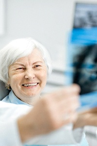Happy senior patient during dental implant recall visit