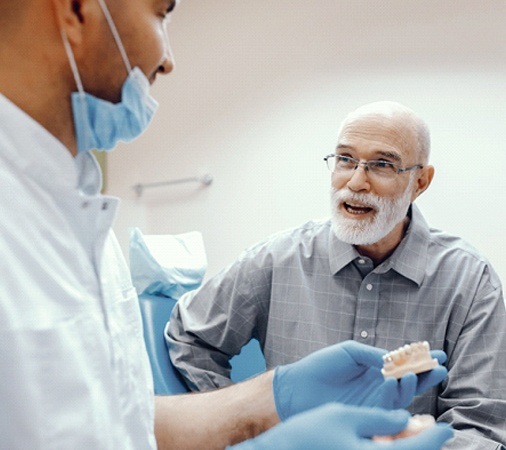 An older man talking to his dentist