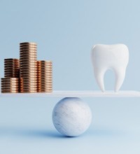A balance beam featuring gold coins and a model tooth