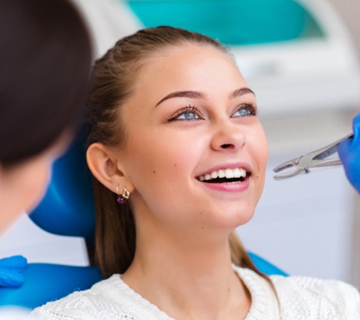 A beautiful girl receiving a tooth extraction