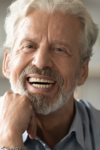 Senior man happy with his investment in dental implants