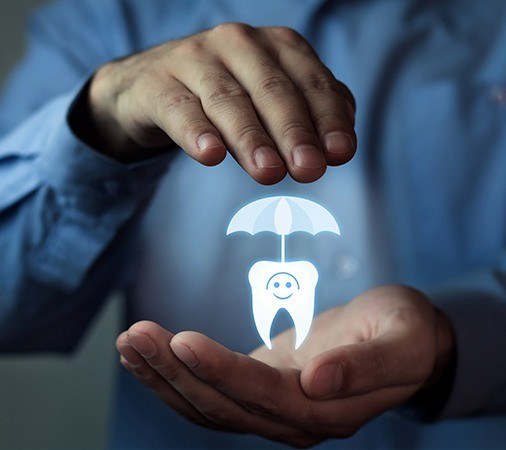 Hands holding an animated tooth and umbrella