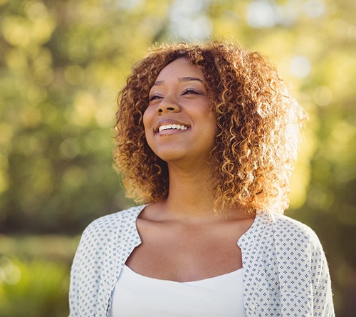 Woman outside smiling after orthognathic surgery in Prosper, TX