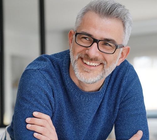 Man smiling at home after orthognathic surgery in Prosper, TX