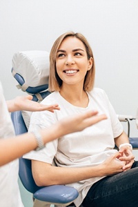 Young woman discussing wisdom teeth extractions with dental professional