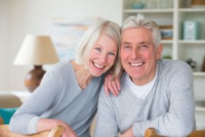 senior couple in their living room after a dental bone graft 