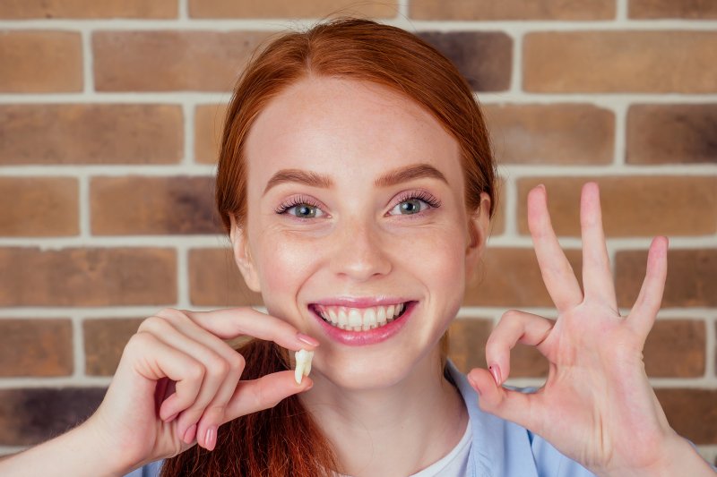 Woman smiling after wisdom tooth extraction