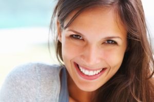 a patient smiling after wisdom tooth extractions