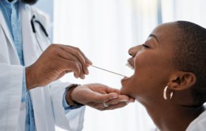 a dentist holding an oral cancer ribbon